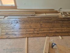 A room filled with wooden boards and a spray bottle.