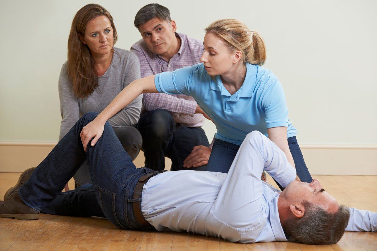 man lying on the floor reciving CPR