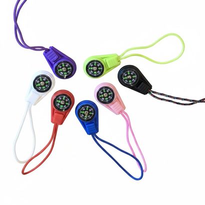 Seven colorful compasses, each with a different colored body and cord, arranged in a circular pattern.
