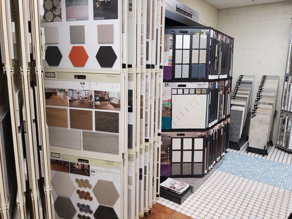 Store aisle with tile and flooring sample displays in a showroom