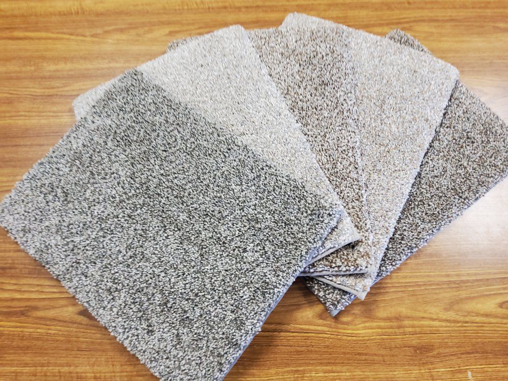 Stacked gray abrasive sanding sheets on a wooden surface