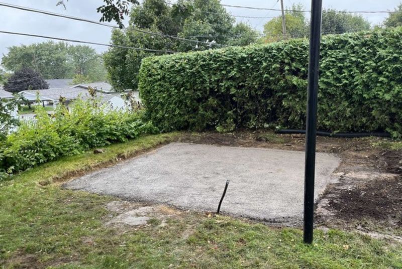 Un terrain de basket est en cours de construction dans l'arrière-cour d'une maison.