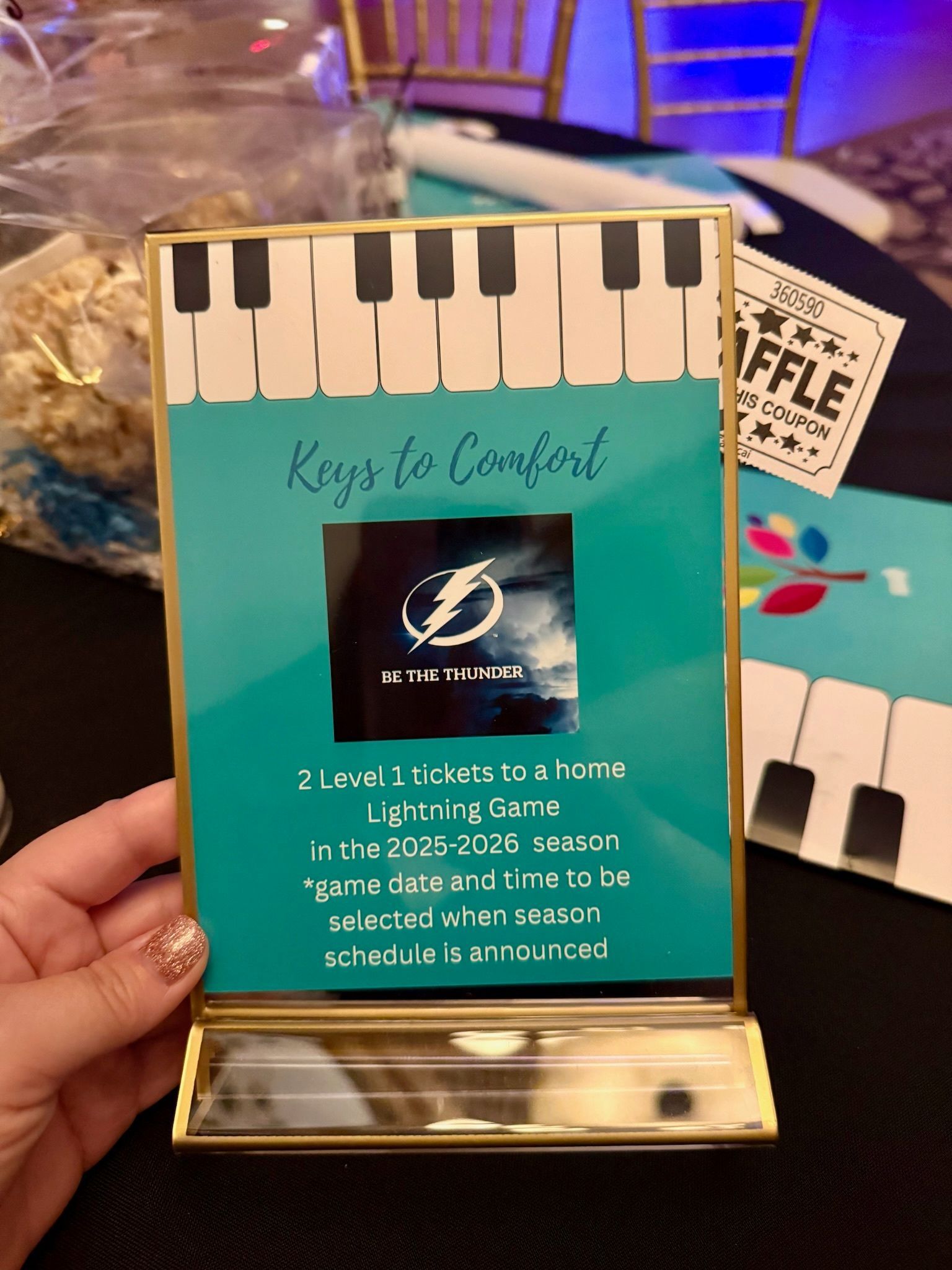 A person is holding a sign that says keys to comfort