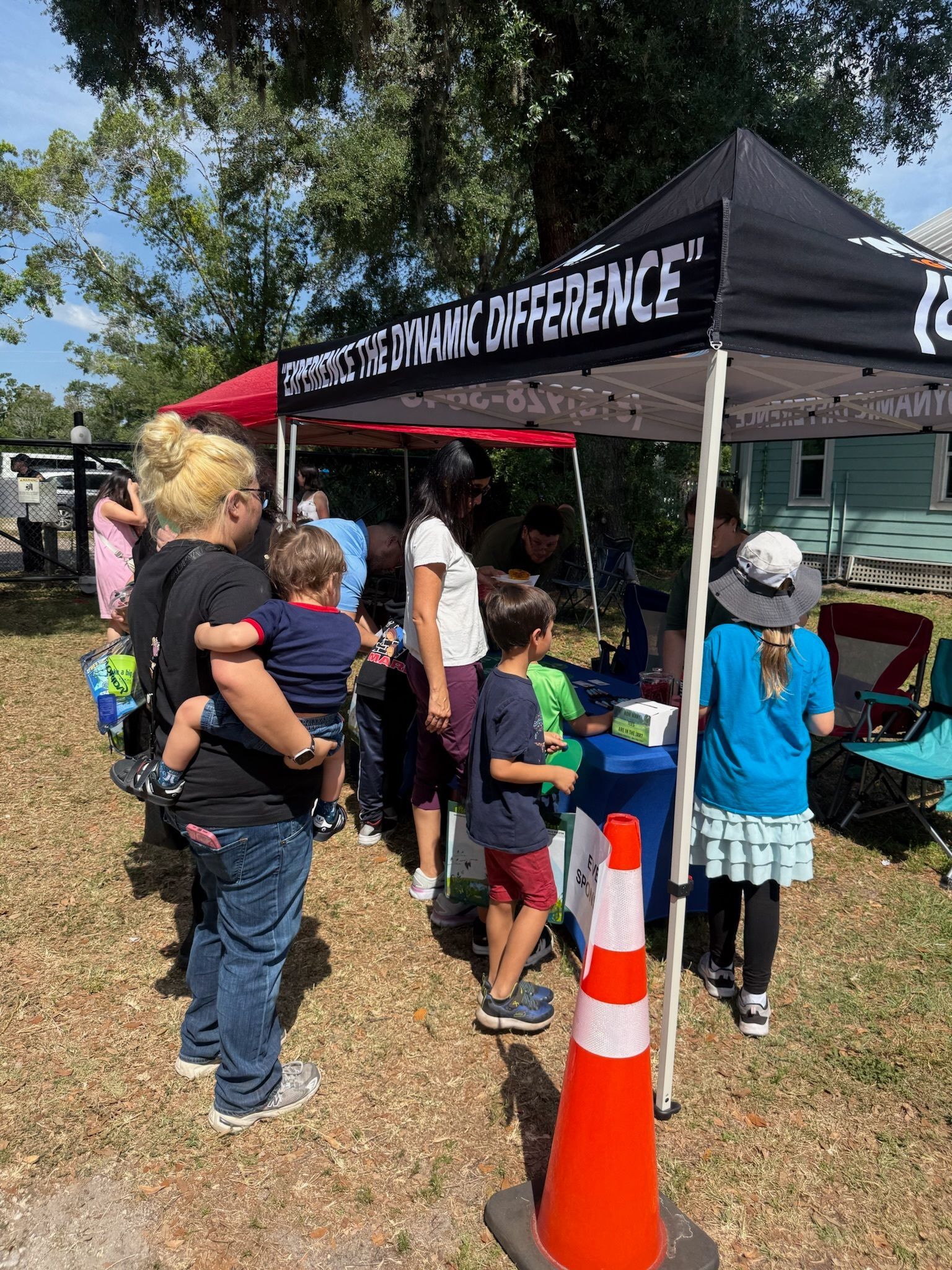 A group of people are standing in front of a tent.