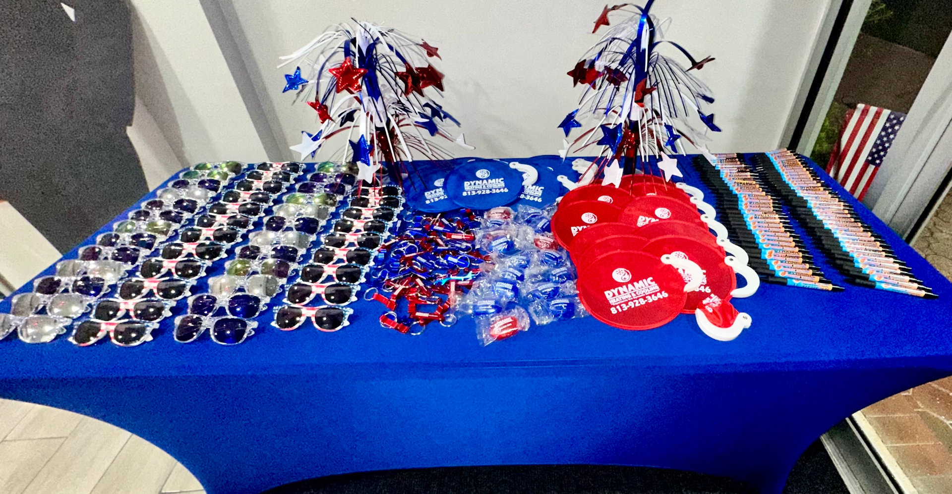 A table with sunglasses , hats , and decorations on it.