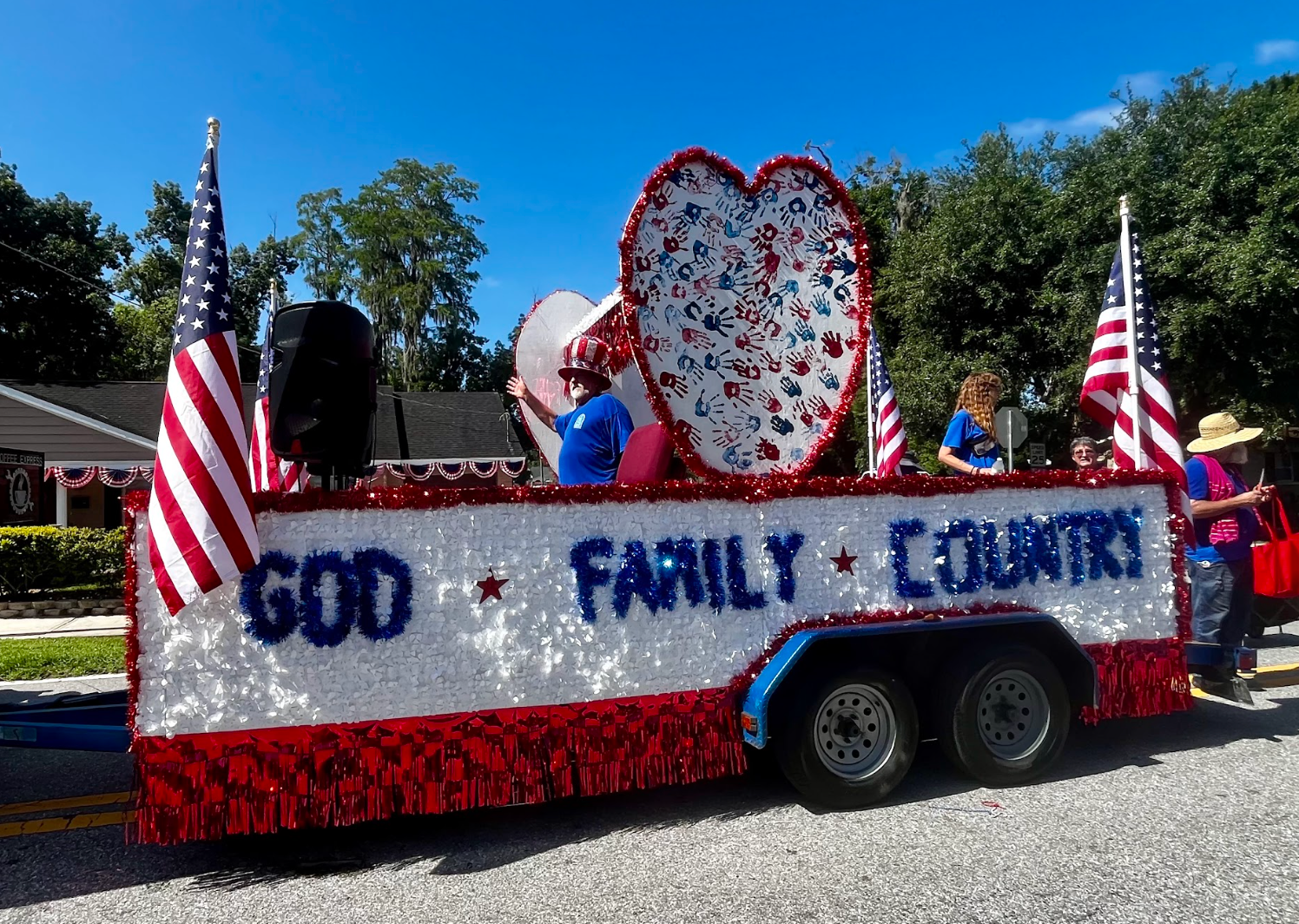 A float in a parade that says god family country