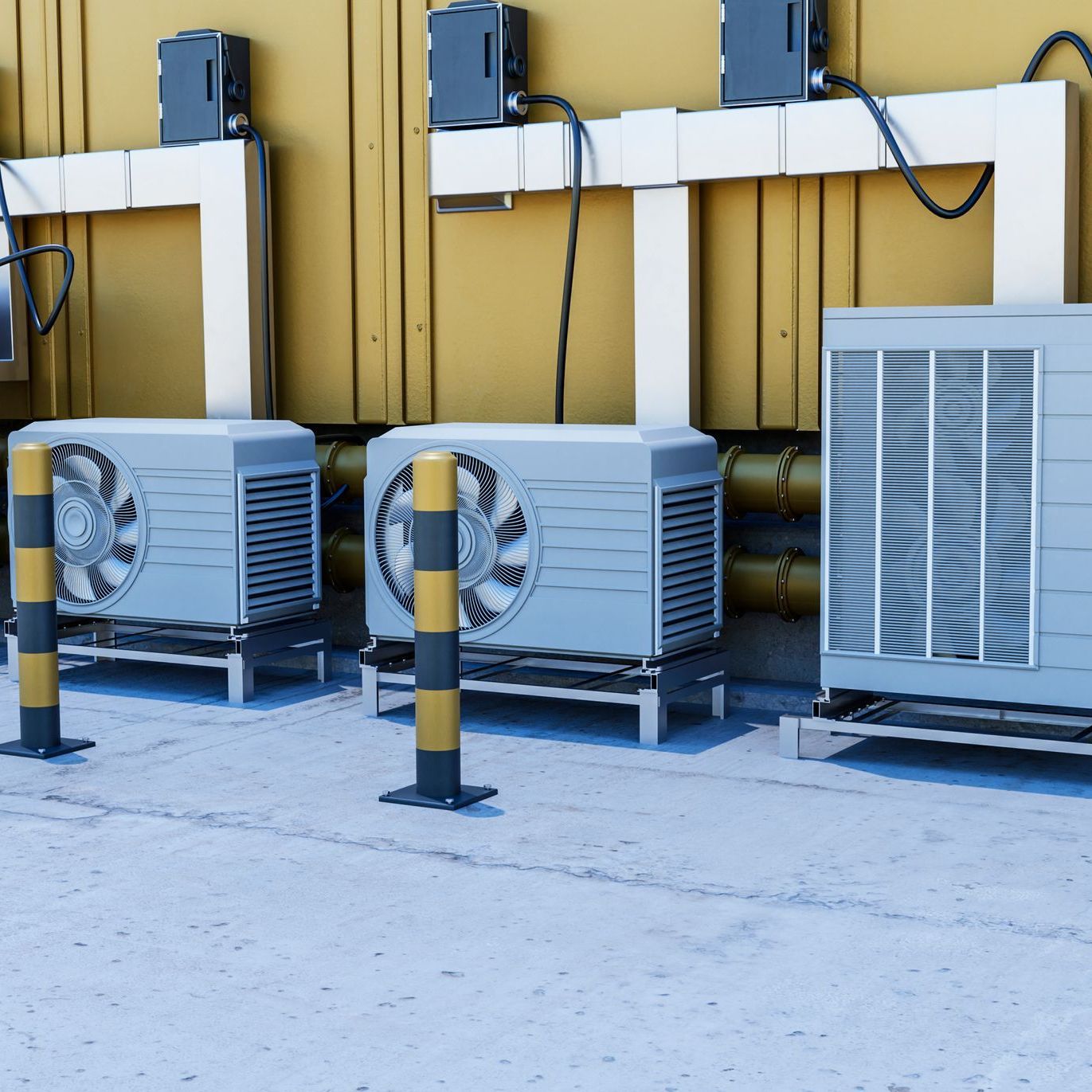 Three air conditioners are lined up in front of a building