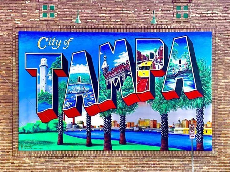 a painting of the city of tampa on a brick wall