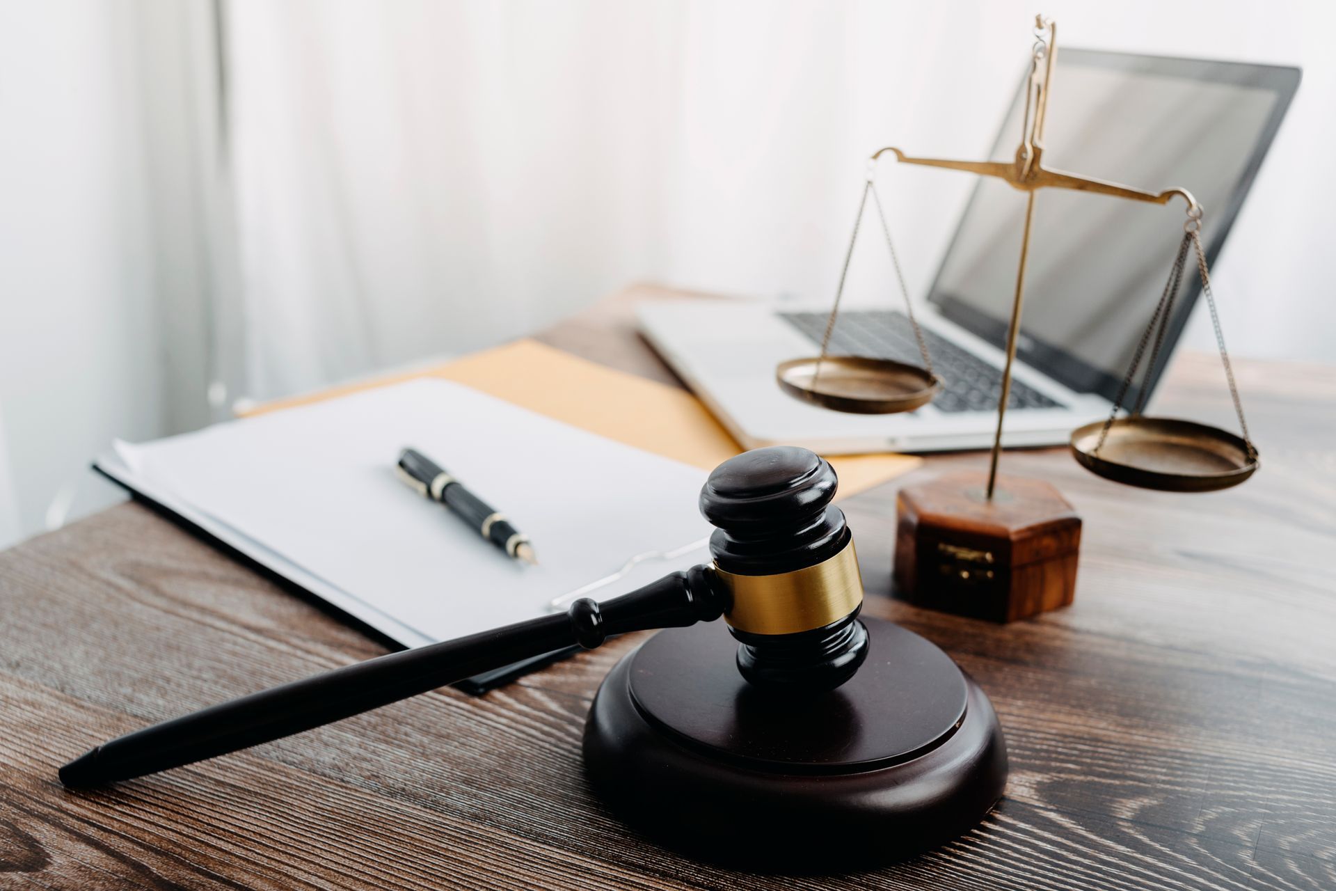 Judge's gavel, scales of justice, and legal documents on a desk