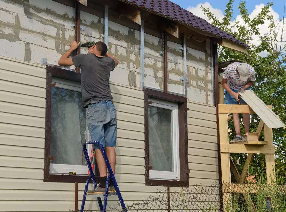 a man paints a wall with a paint roller