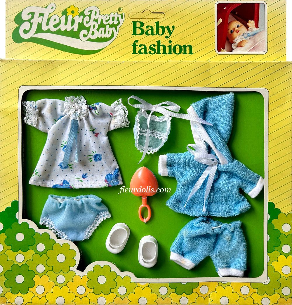 Fleur doll Pretty Baby Fashion box for a boy with a white-blue shirt, hoodie, shorts, shoes and pink rattle.