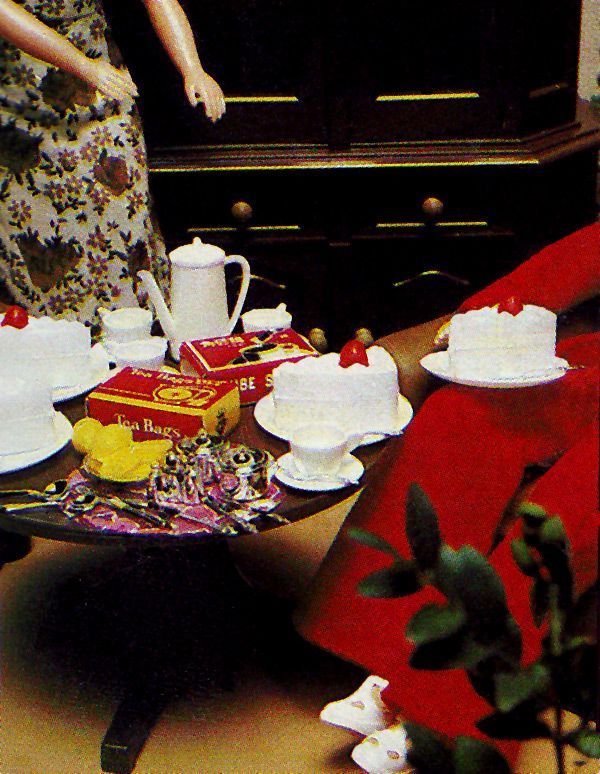 Fleur doll coffee and cake service served on round coffee table with tea