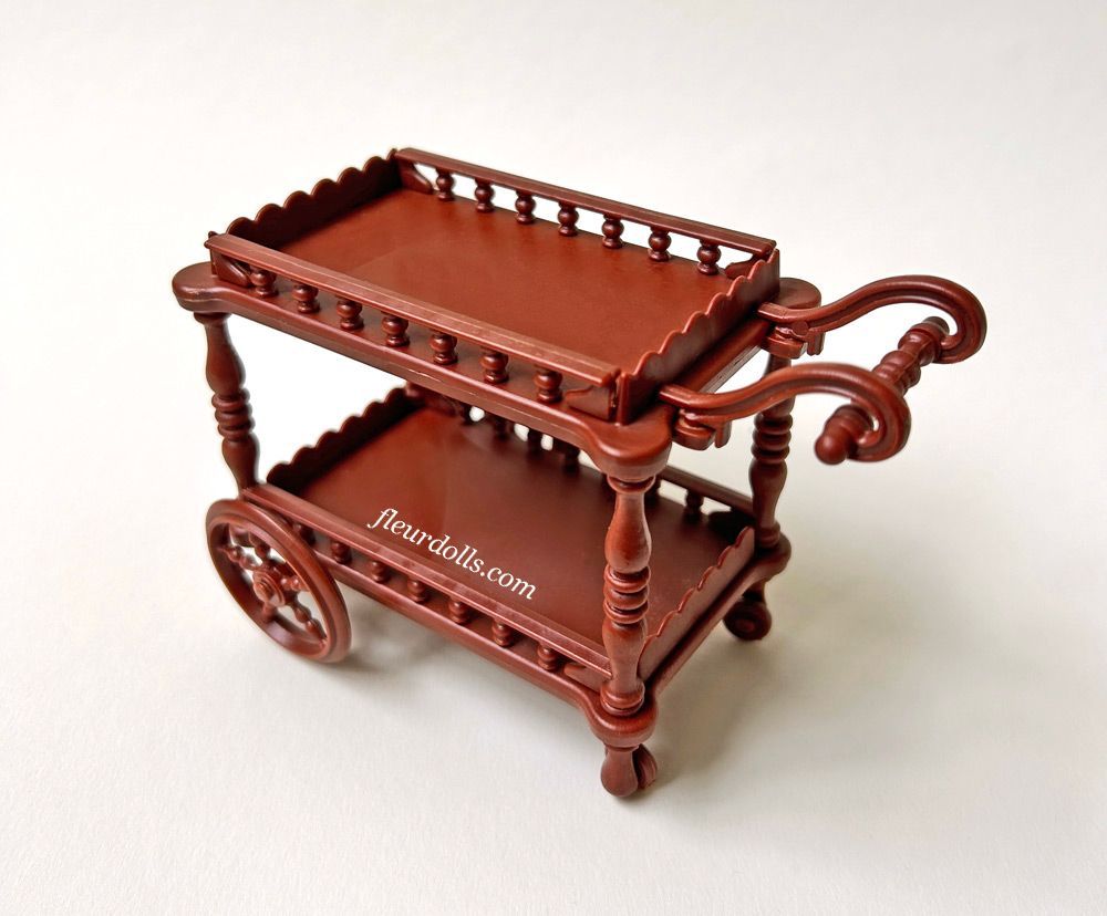 Fleur doll brown tea trolley with four wheels, scalloped edges and rounded handle 1980s