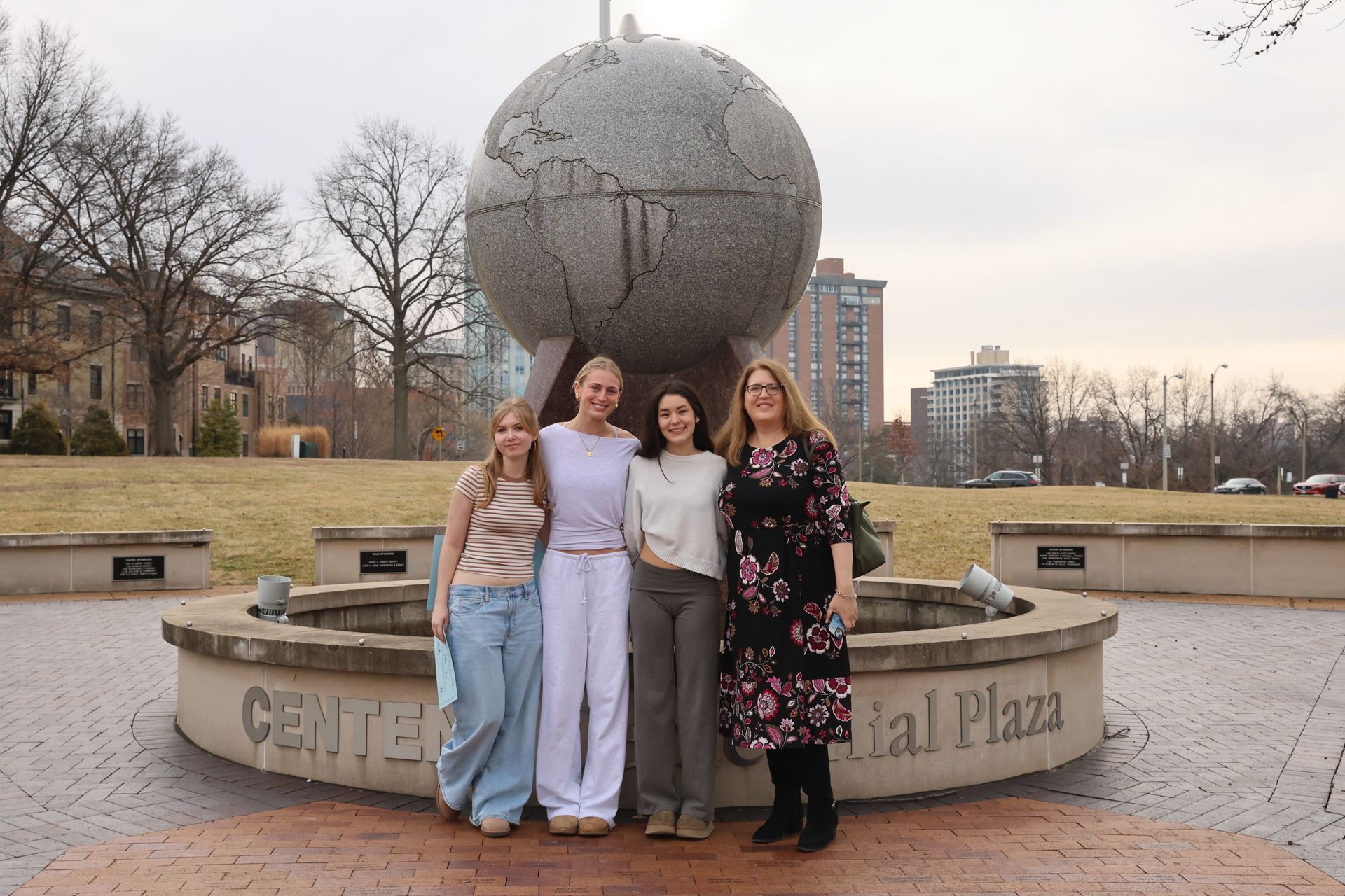 Modern glass and steel buildings under a wooden pergola on a sunny day.