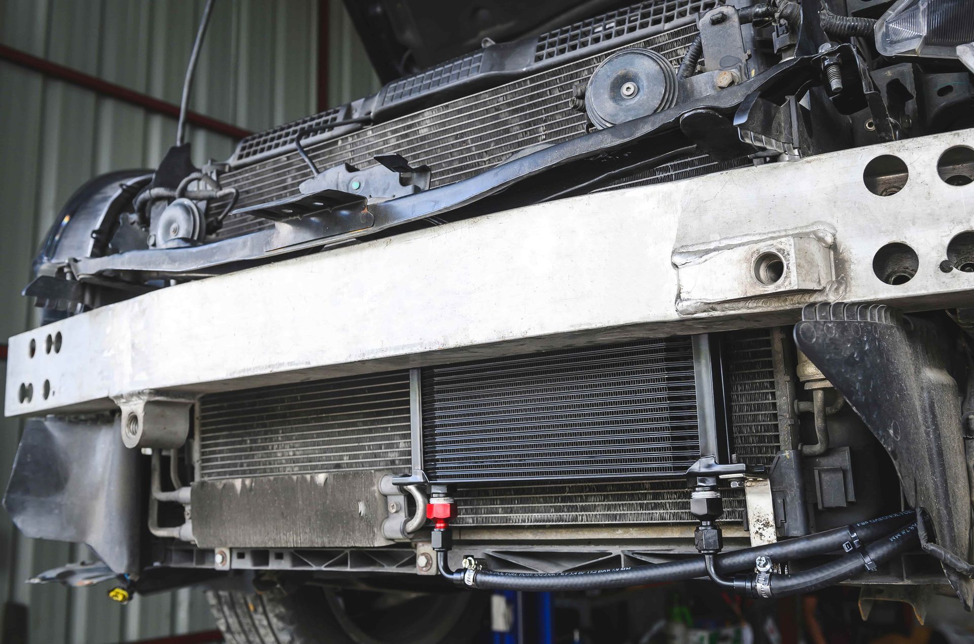 A Person is Working on the Radiator of a Car — Radiator Doctor In Pialba, QLD