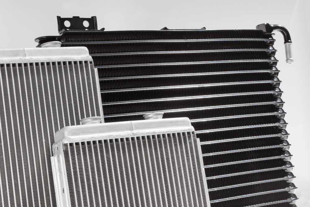 A Black and White Photo of Three Radiators on A White Surface — Radiator Doctor In Pialba, QLD