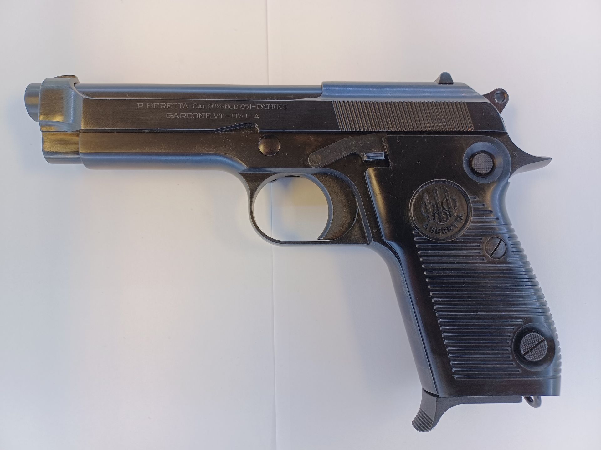 Black Beretta 1935 pistol on a white background.
