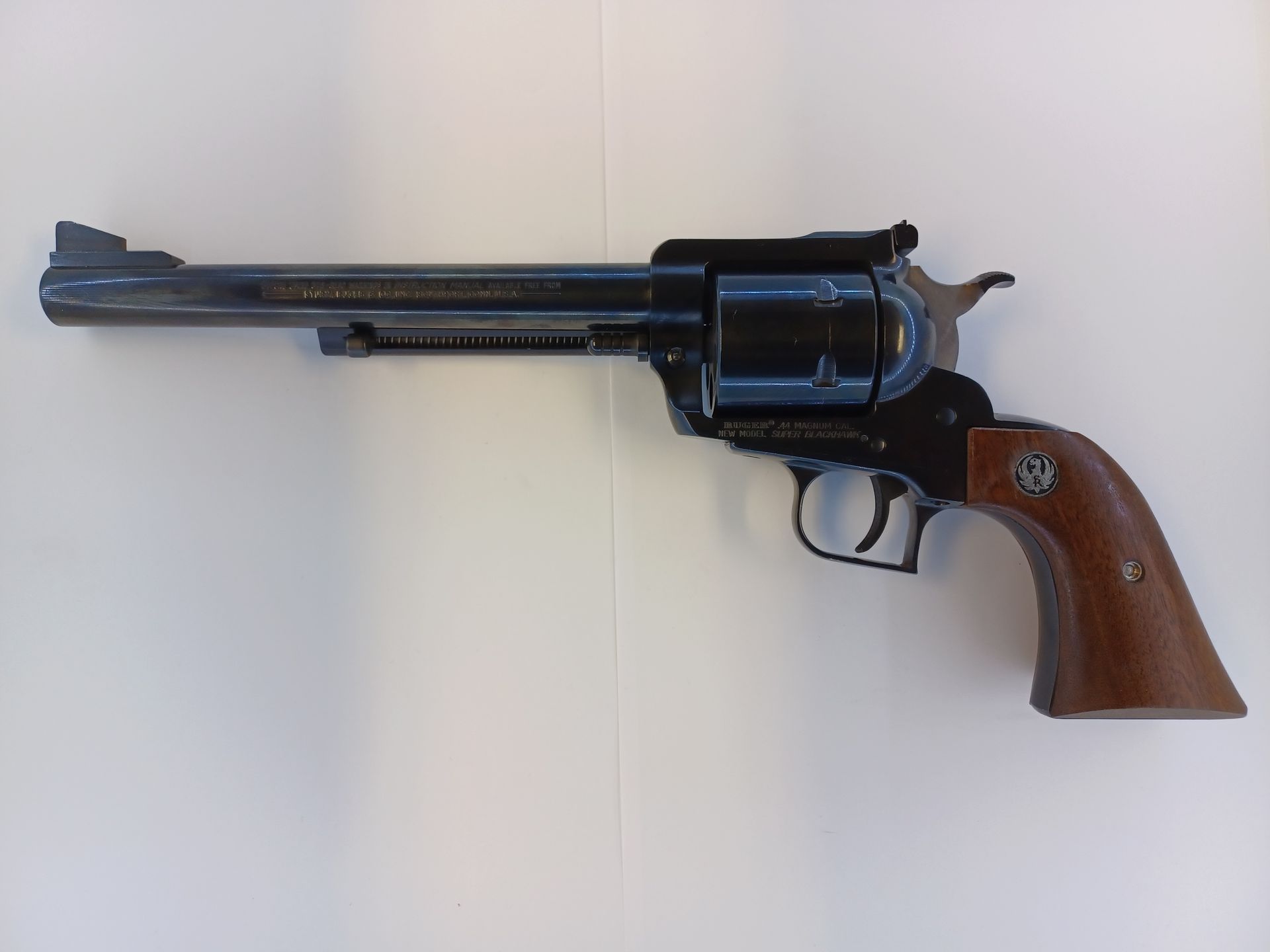 Black and brown revolver on a white surface.