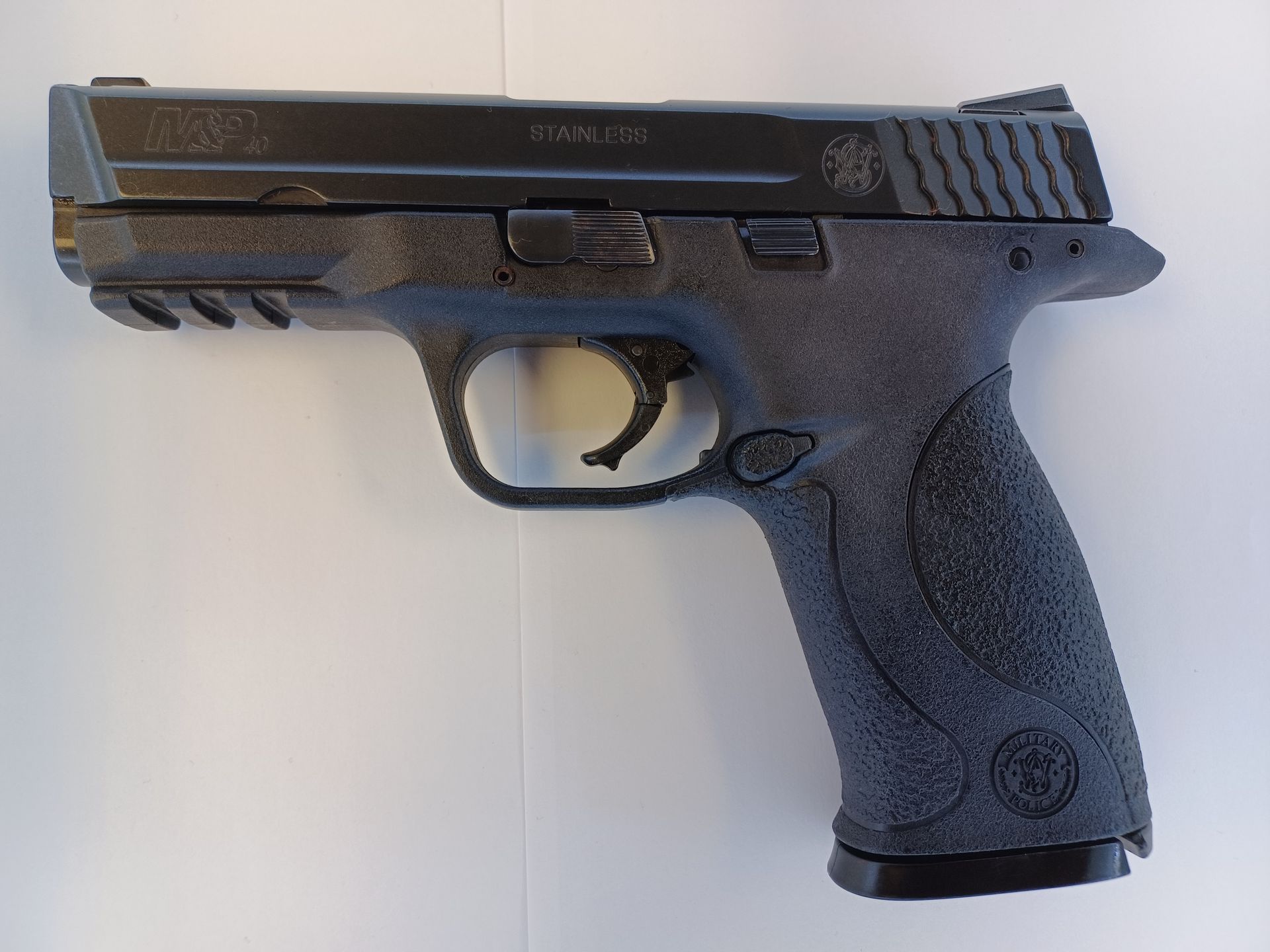 Black Smith & Wesson M&P pistol on a white surface.