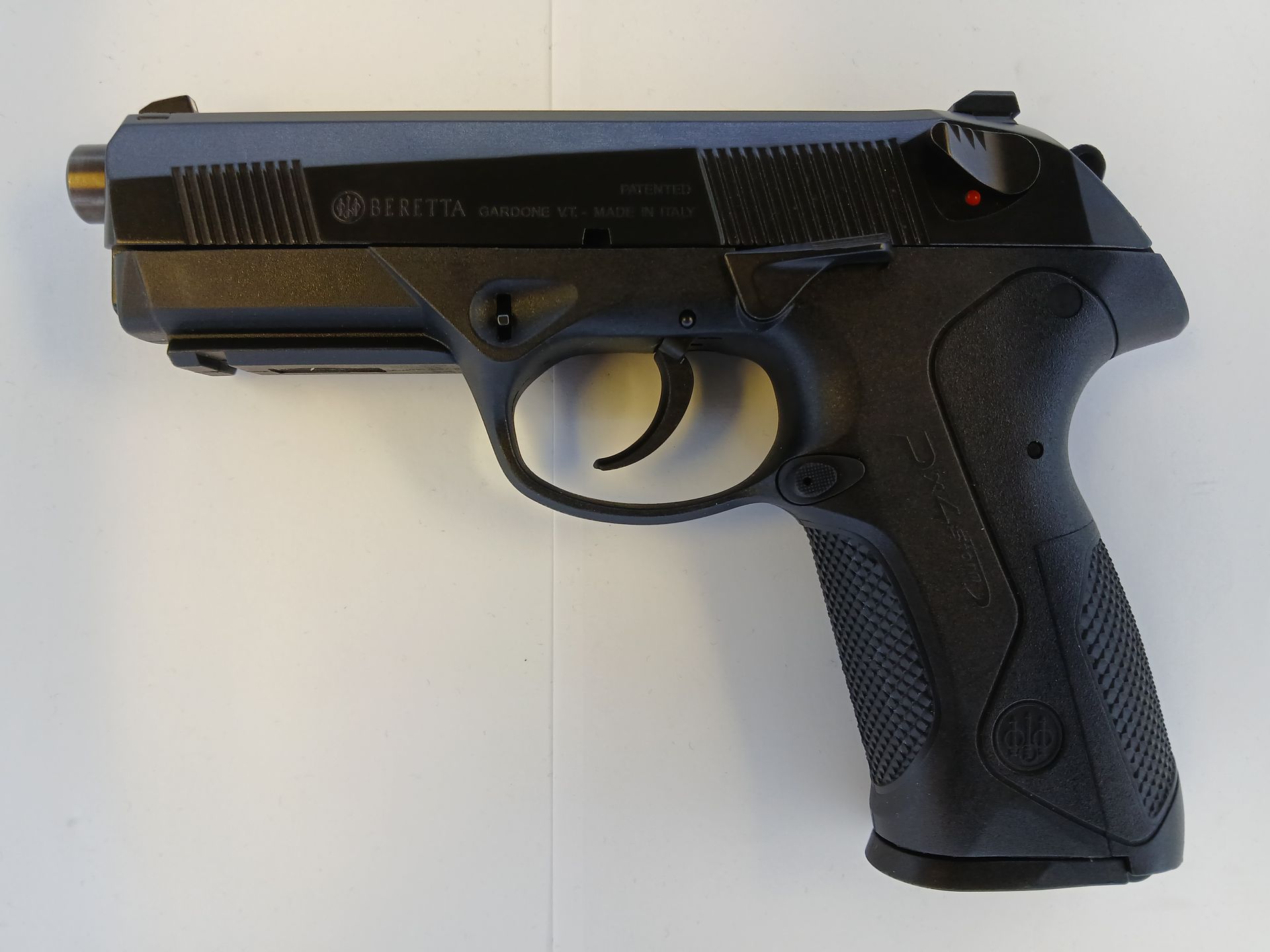 Black Beretta PX4 Storm pistol on a white surface.