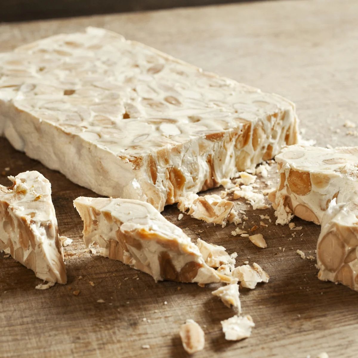 Turron on a wooden plate in pieces