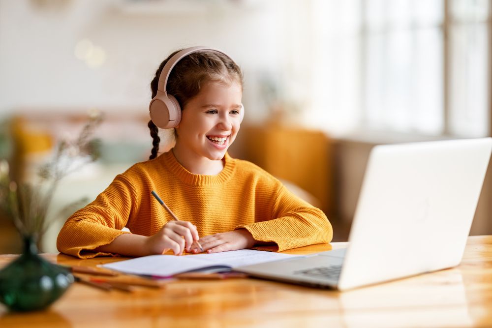 School Girl In Headphones Communicating With Tutor — Al Roberts Education Centre in Wynnum West, QLD