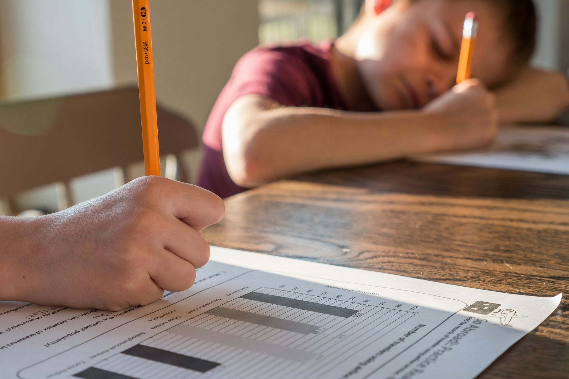 A Boy Is Writing on A Workbook — Al Roberts Education Centre in Wynnum West, QLD