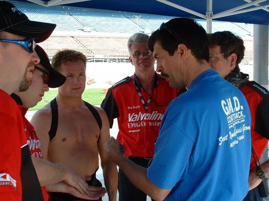 A man wearing a blue shirt that says g.u.d.