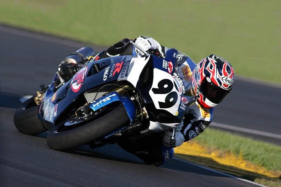 A man is riding a motorcycle with the number 96 on it