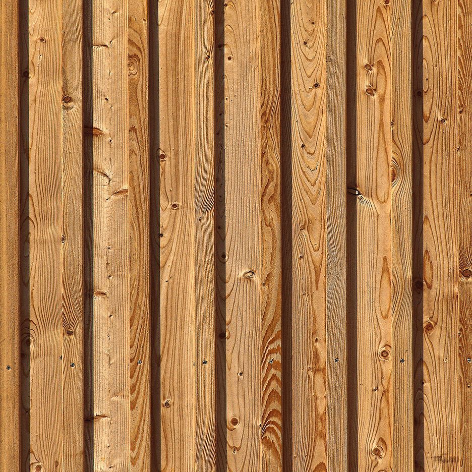 Vertical wooden paneling with alternating light and dark brown stripes.