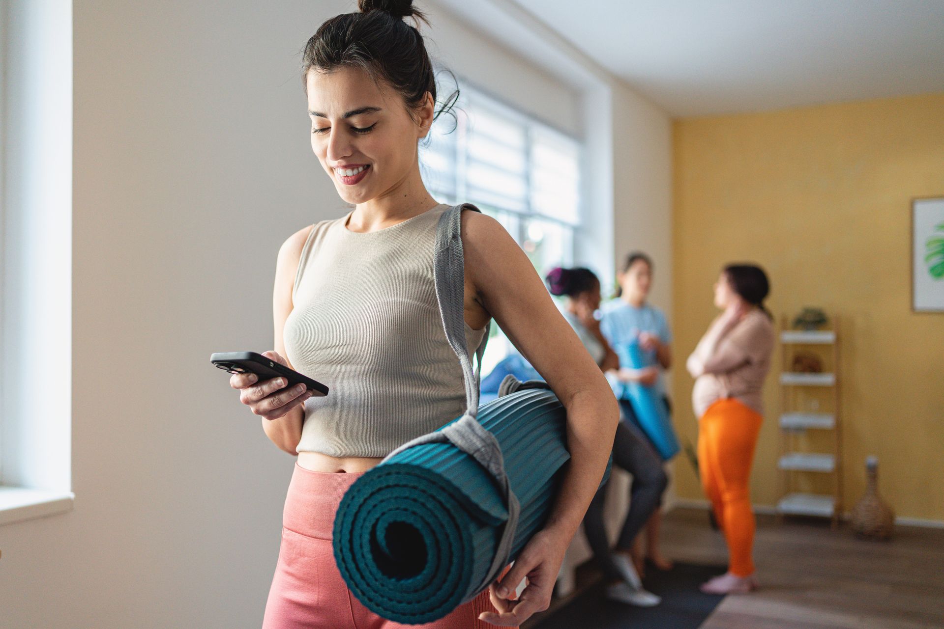 Women Using Phone After Exercise — Goodyear, AZ — Natalie's Fitness Elements Garage