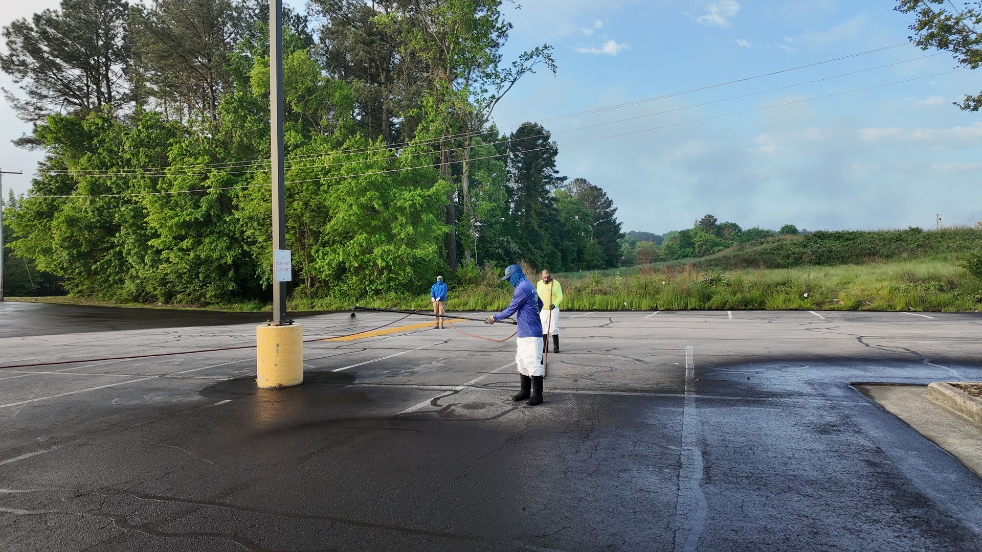 A group of people are standing in a parking lot.