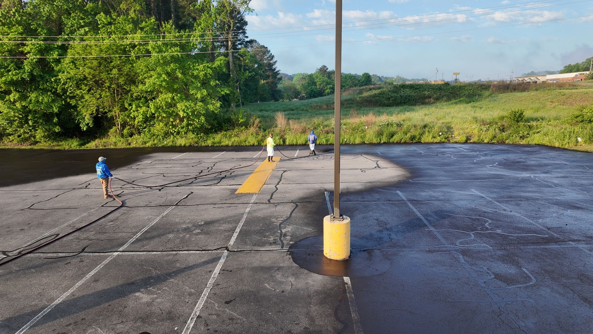 A group of people are standing in a parking lot.