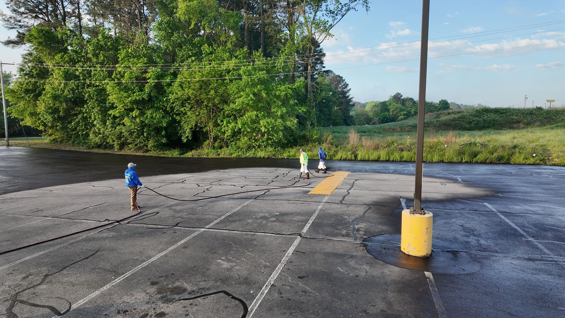 A parking lot with a yellow pole in the middle of it