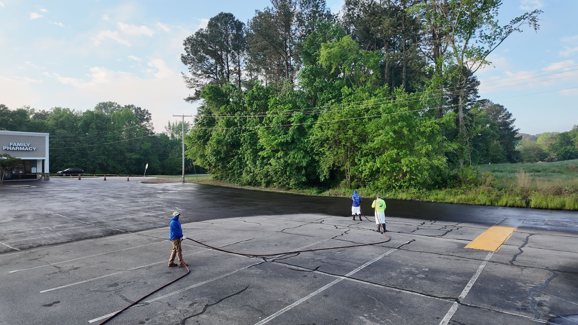A group of people are standing in a parking lot.