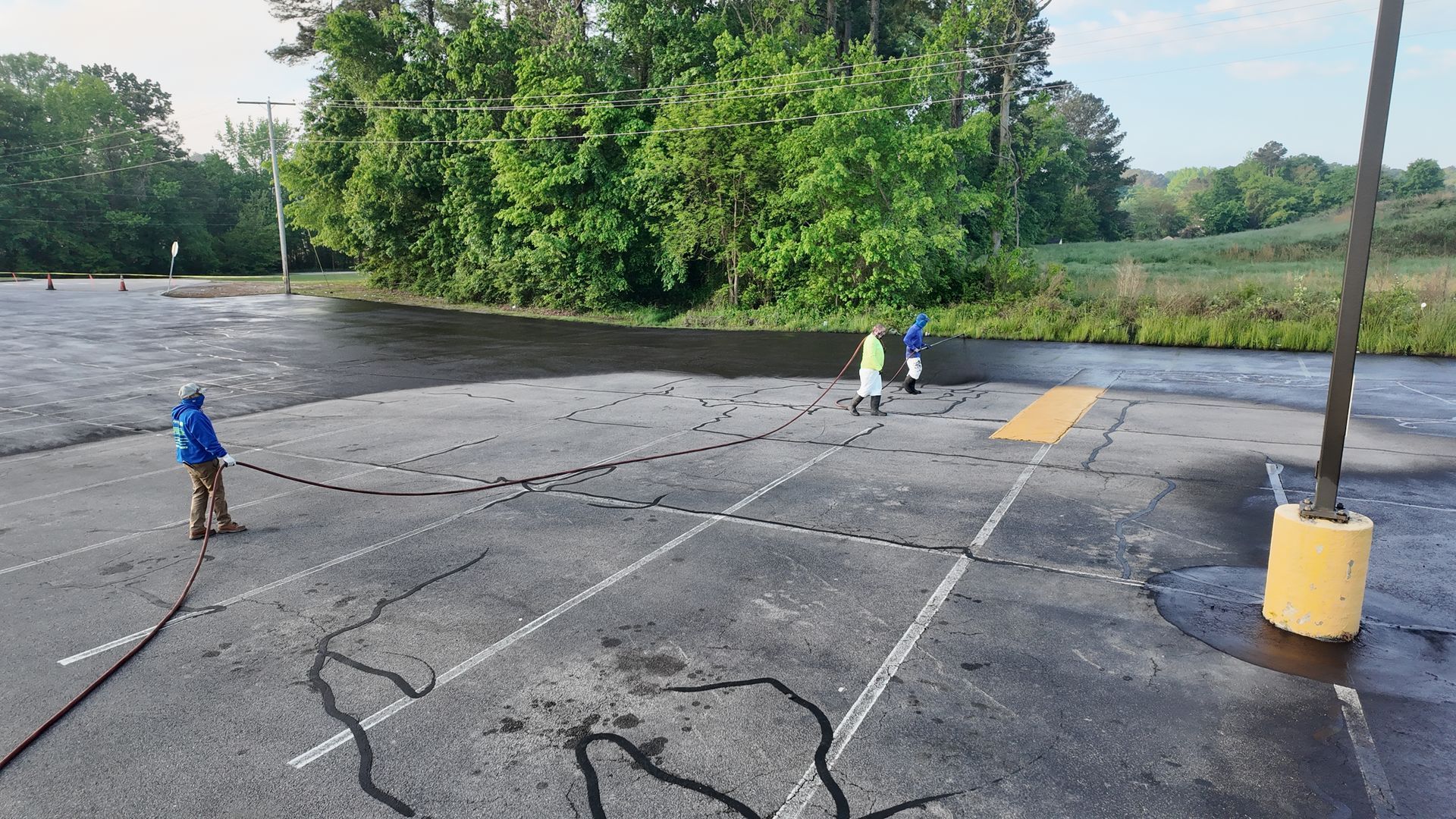 A group of people are standing in a parking lot.