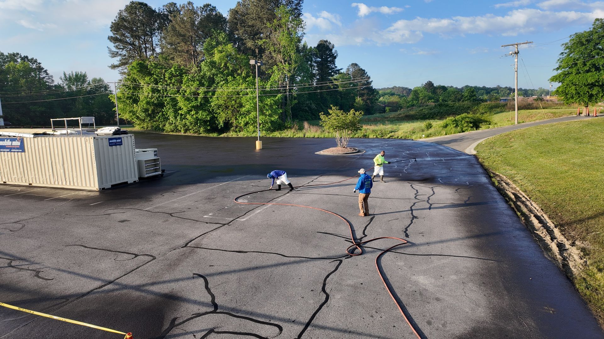 A person is standing in a parking lot next to a fire hydrant.