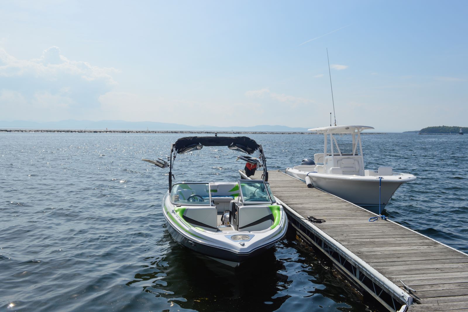 A boat is docked at a dock next to another boat.