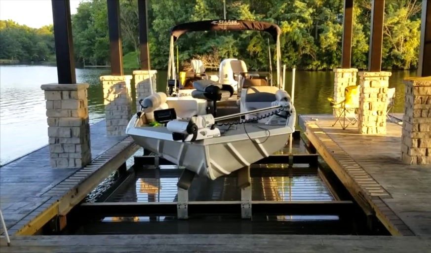 Motorboat on custom boat lift in covered dock by lake in Tampa, FL