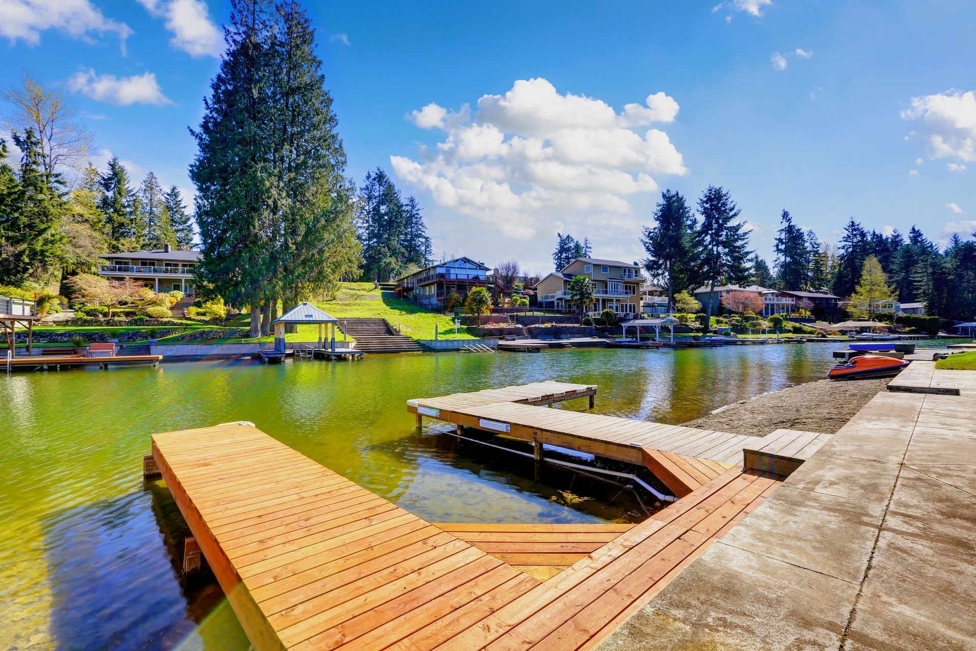 Private dock on a lake in Tampa, FL overlooking homes and boats