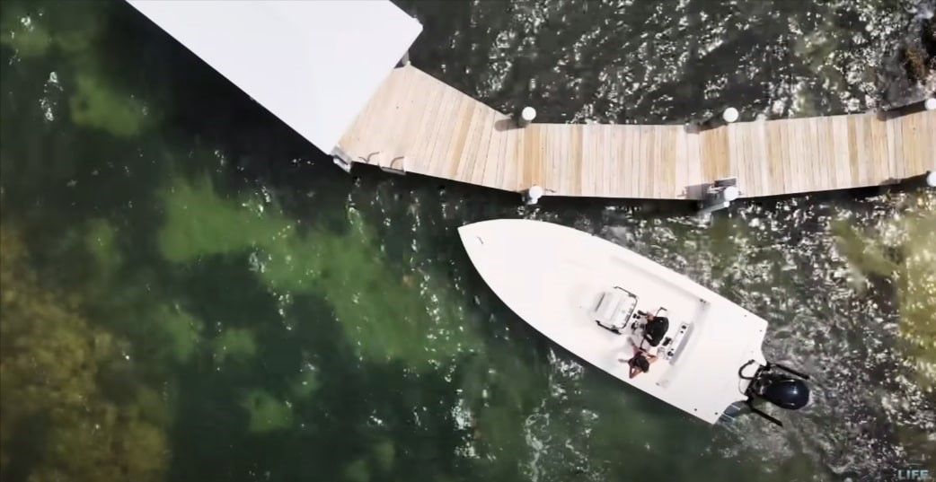 Private boat dock in Tampa, Florida overlooking green water