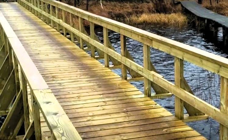 Tampa waterfront wooden boardwalk with railing over water, professional construction for durability 