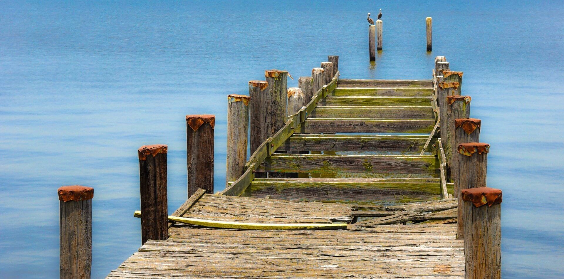 A broken boat dock that needs to be repaired to be usable once again