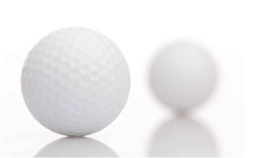 two golf balls on a white background