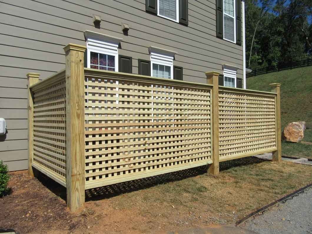 Wooden lattice fence outside a building, light brown color.