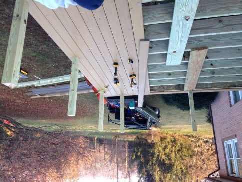 Construction of a deck; wood planks are being installed.