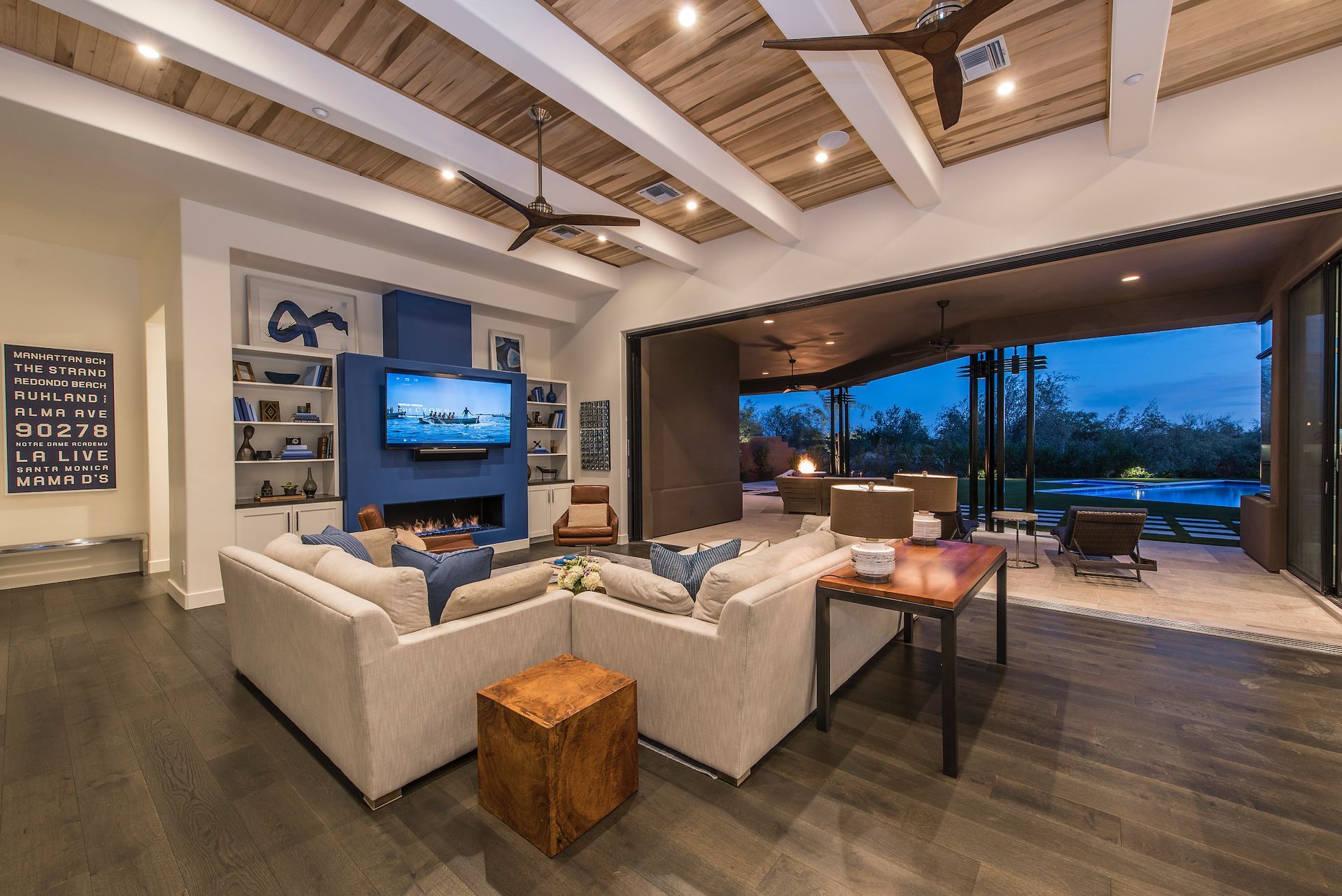 A living room with a large sectional couch and a flat screen tv.