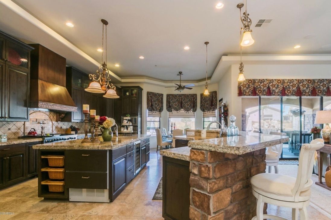 A large kitchen with a large island in the middle of it.