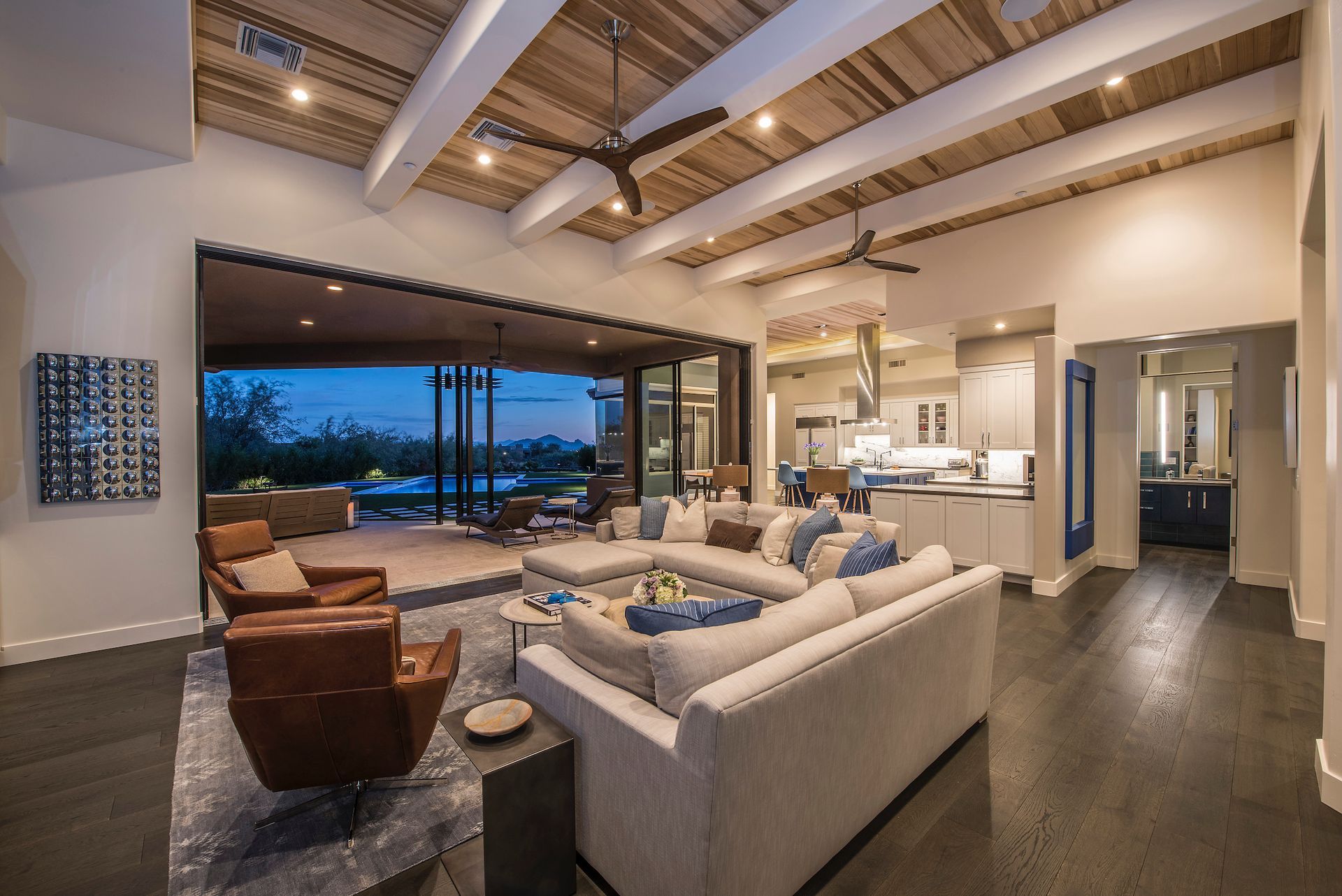 A living room with a couch , chairs , and a ceiling fan.