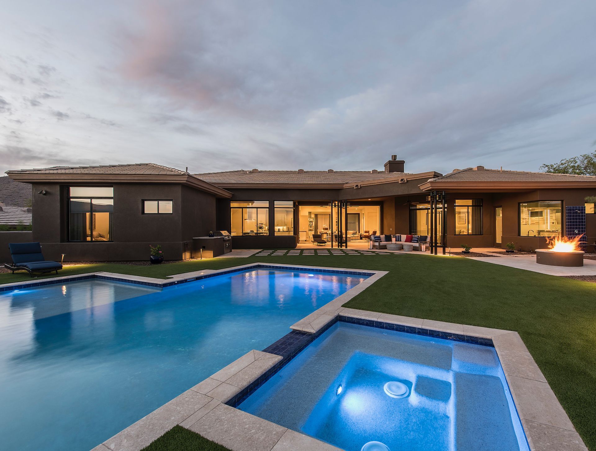 A large house with a large swimming pool and a hot tub
